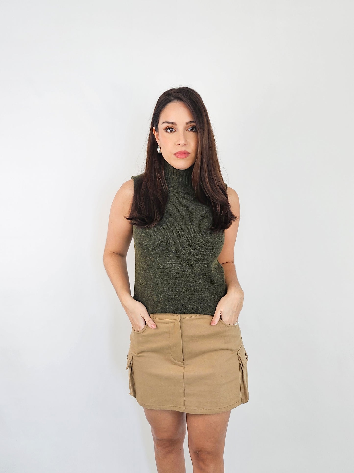 Mini Khaki cargo skirt. Showing the pockets as it has two front pockets and two side pockets.