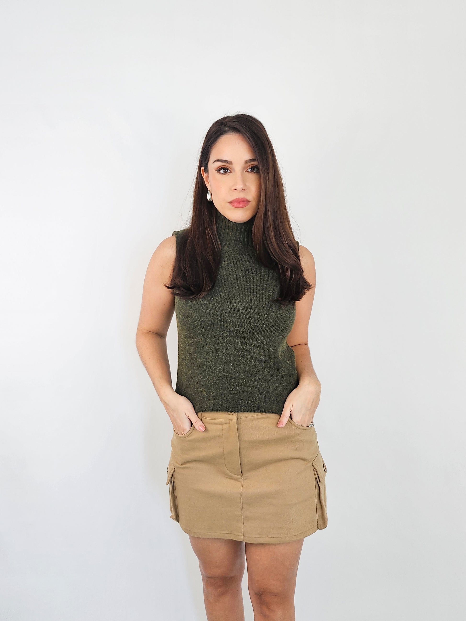 Mini Khaki cargo skirt. Showing the pockets as it has two front pockets and two side pockets.