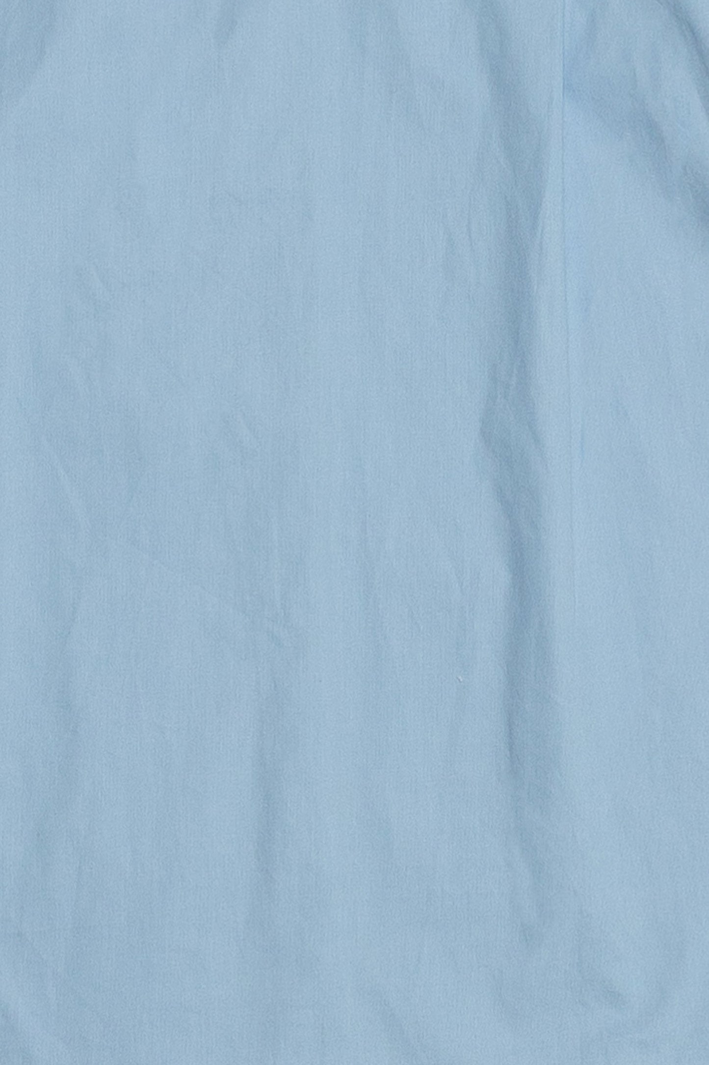Up close of the blue button down shirt fabric showcasing the 100% cotton. This shirt is a staple piece and will last in your wardrobe.