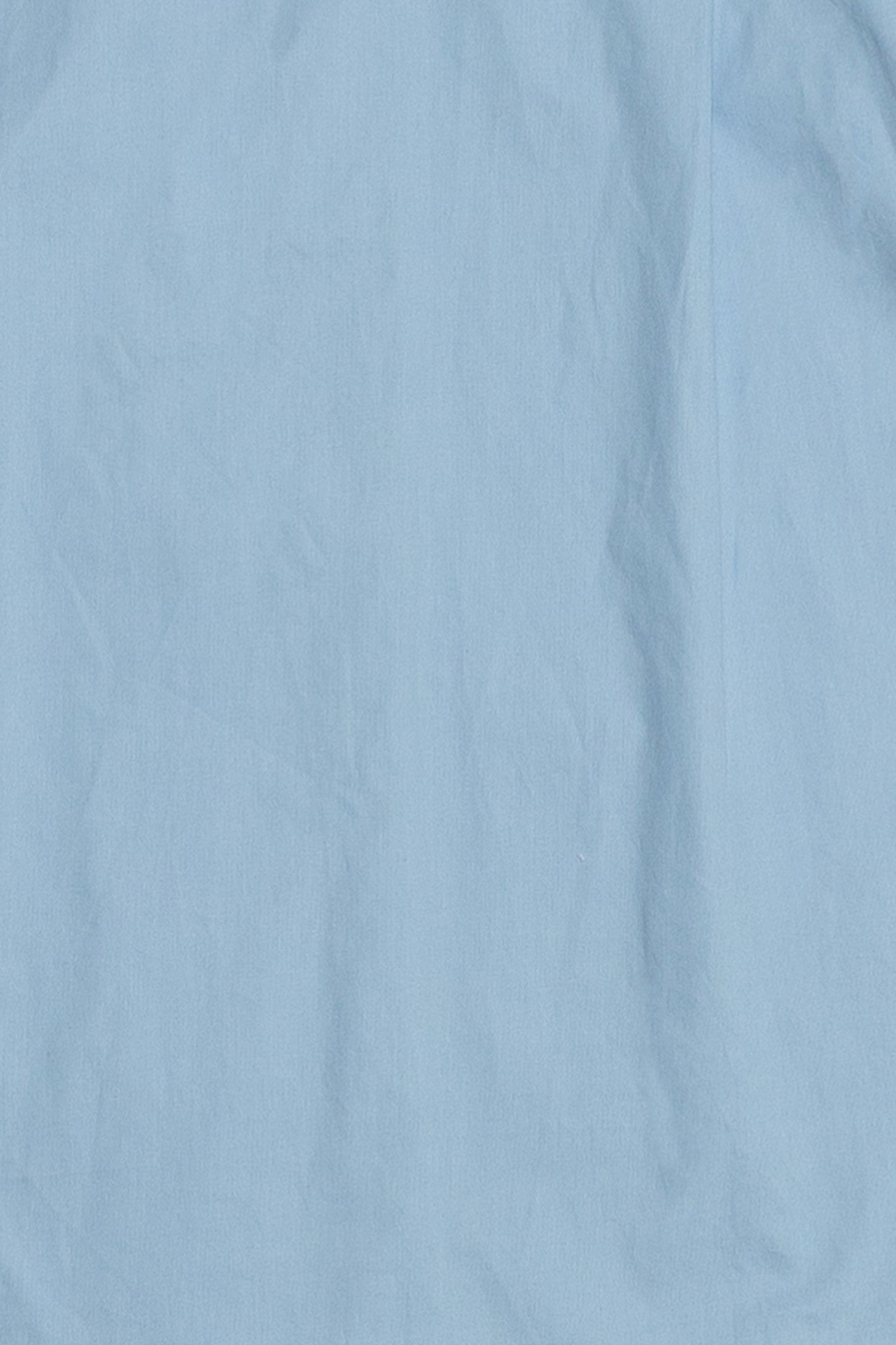 Up close of the blue button down shirt fabric showcasing the 100% cotton. This shirt is a staple piece and will last in your wardrobe.