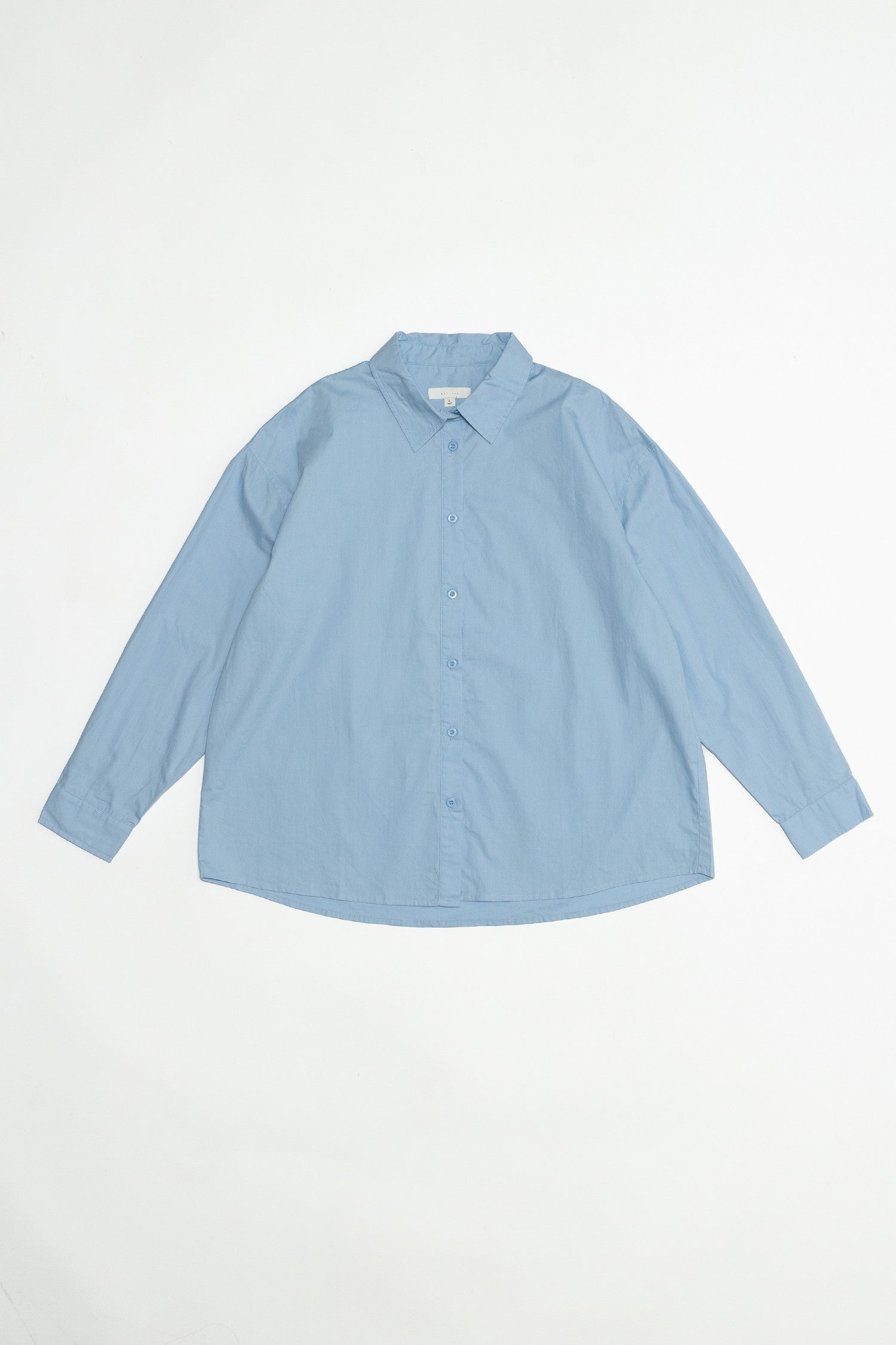 Photo of the oversized blue button up shirt making it a perfect staple piece in your wardrobe.