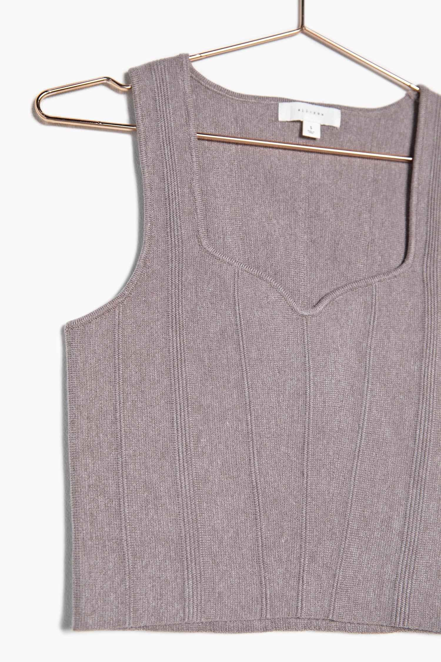 Close up of the brown knit crop top showing more detailing of the top as well as a closer look at the neckline which is so elegant and classy.
