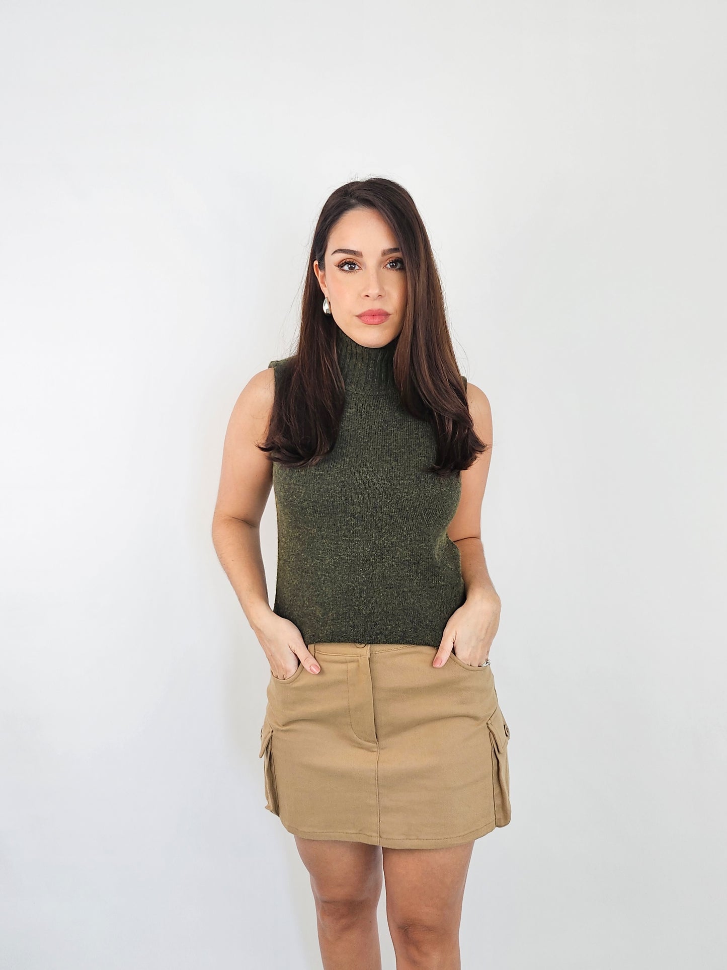 Mini Khaki cargo skirt. Showing the pockets as it has two front pockets and two side pockets. 